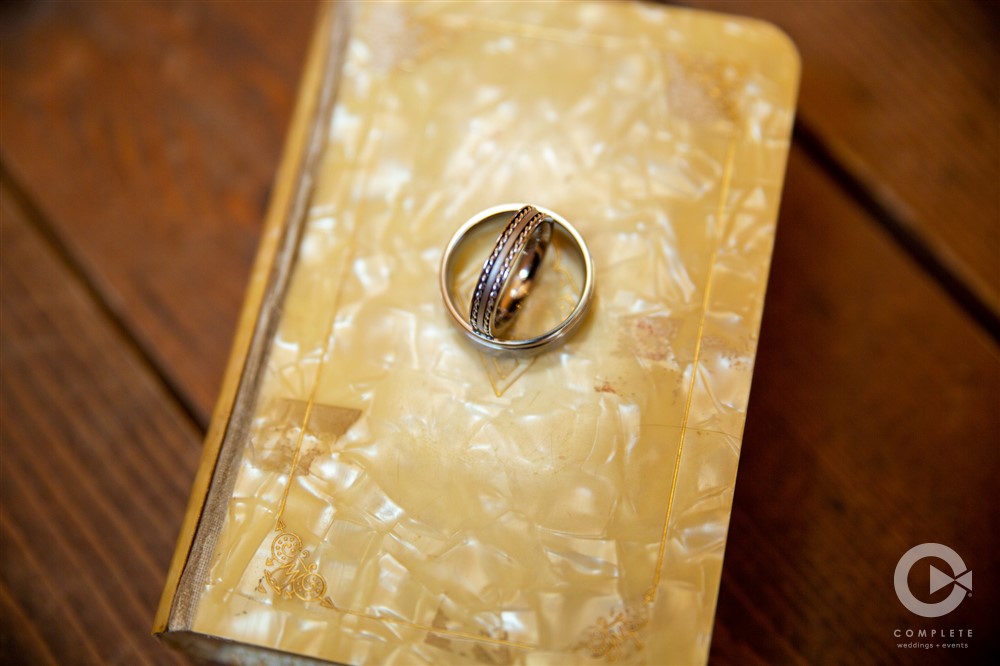 focus shot of wedding rings on tortiseshell notebook