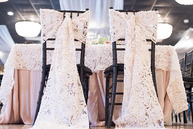 Lace chair coverings on black chiavari chairs