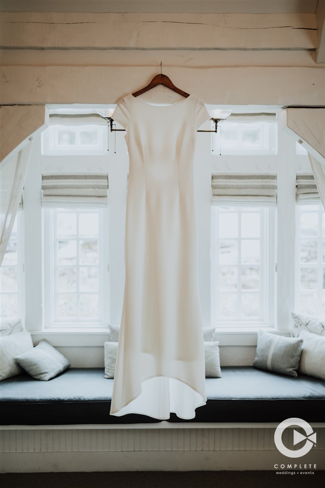 Simple white wedding dress hanging at Big Cedar Spa
