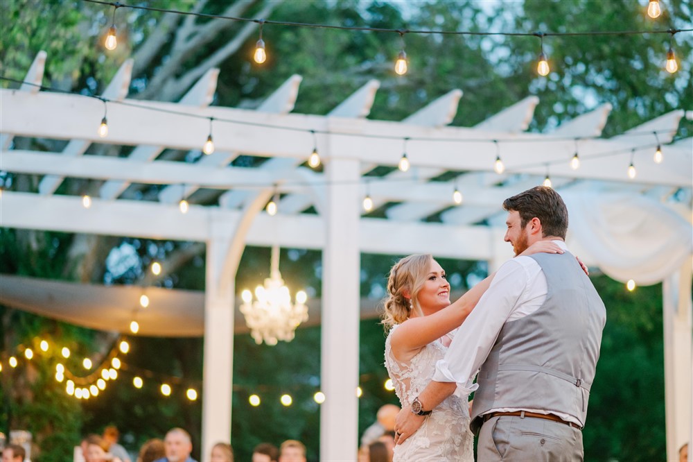 Bride and groom first dance under pergola at Haseltine Estates