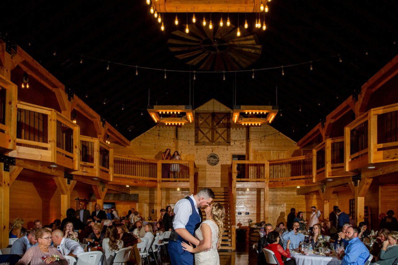 couples first dance inside barn at Venue at Stockton Lake