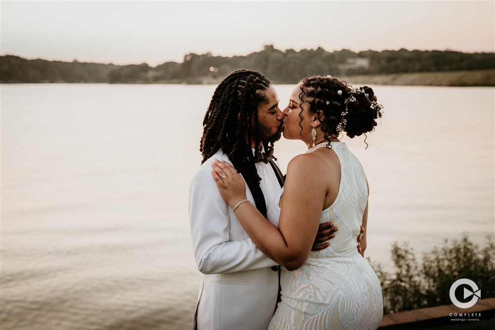 Couple Kissing with scenic lake in background in Northwest Ar