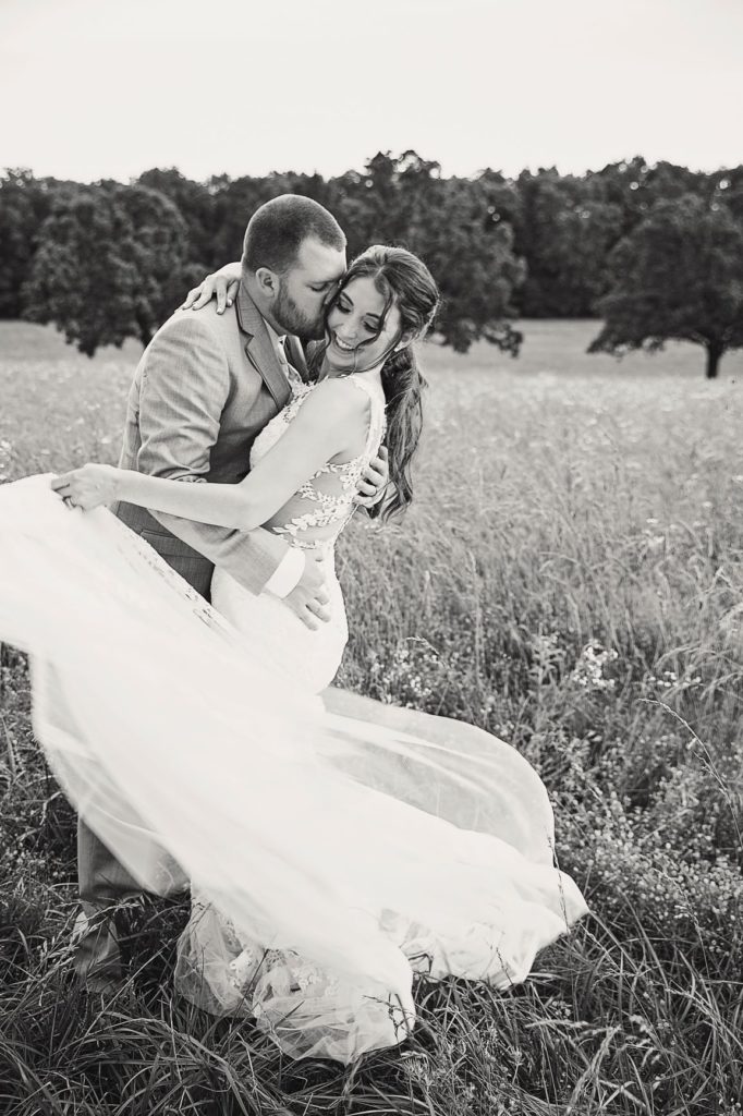 bride and groom dancing in a field | country wedding at the Gambrel Barn