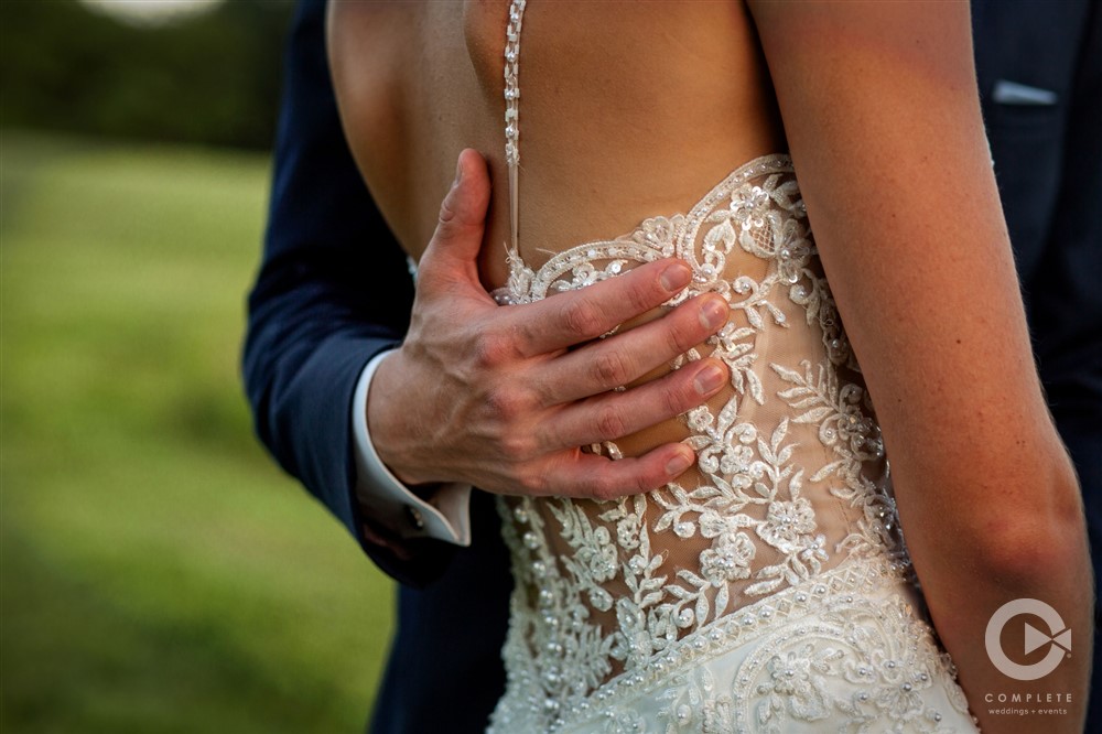 Payton & Jacob groom's hand on the back of bride close shot