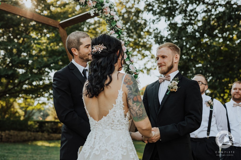 bride and groom looking at each other and holding hands