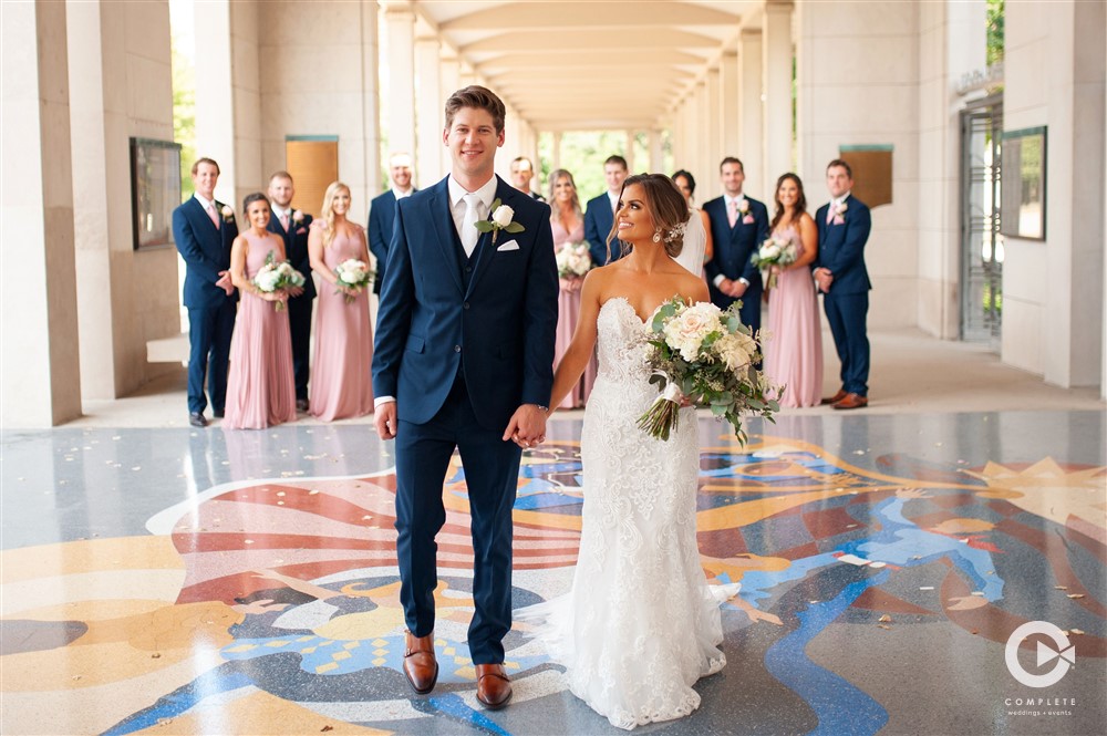 Bride and groom walking with bridal party