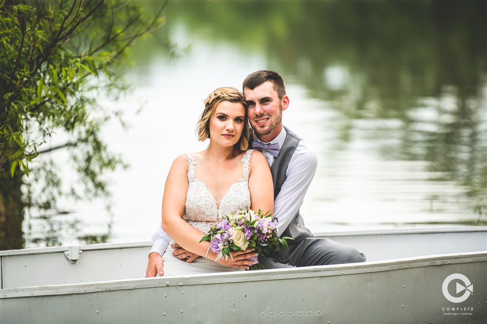 wedding couple in boat. complete wedding and events photography.