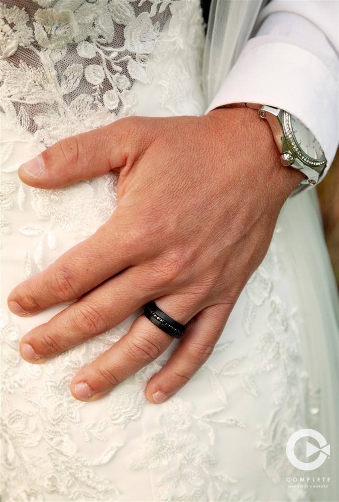 Groom's hand on bride