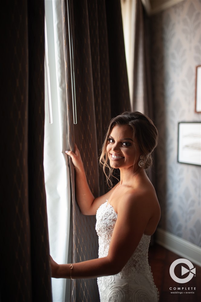 Bride looking out of window during wedding