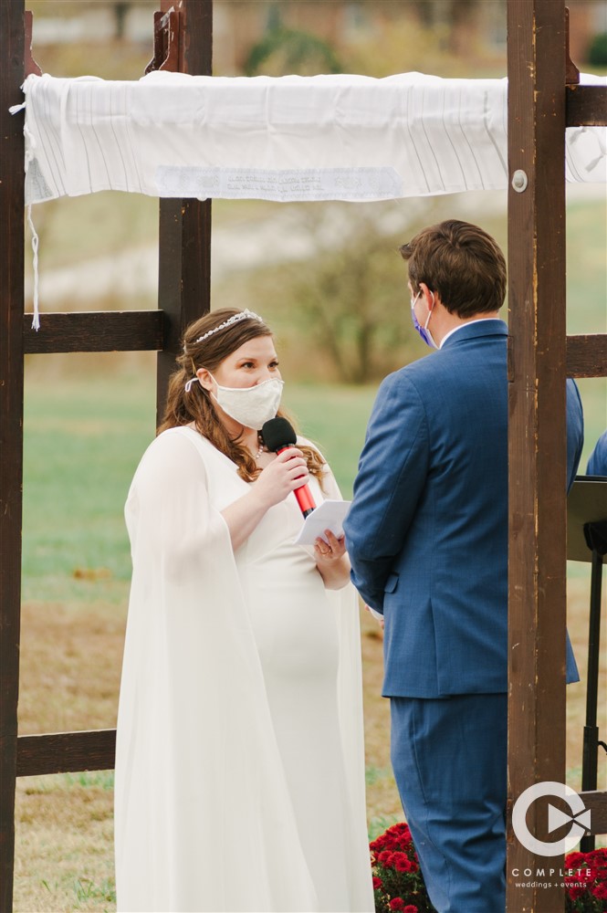 Reading Vows in an Outdoor Missouri Wedding Ceremony