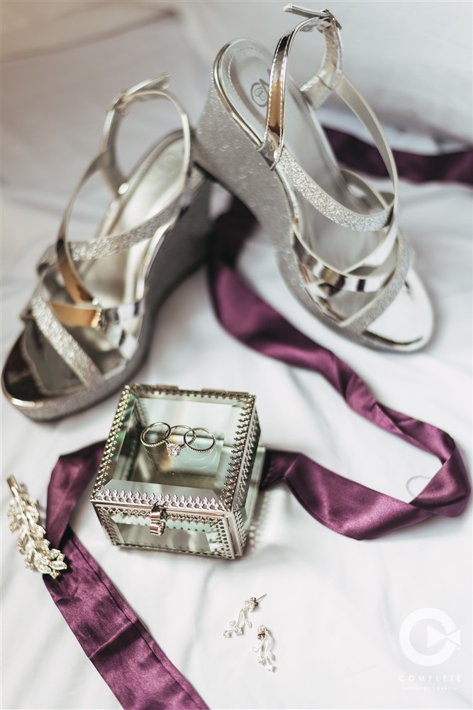 Kranzberg Arts Foundation wedding detail shot of shoes and wedding rings in glass case