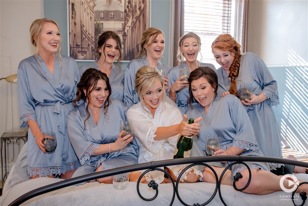 Bridal Party popping the bubbly