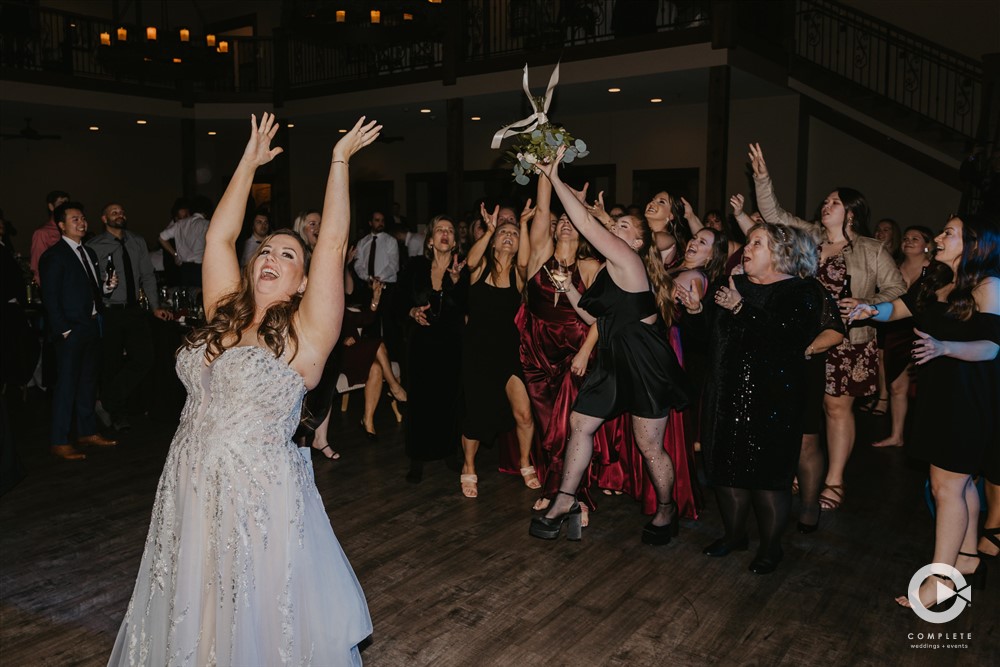 Complete Weddings + Events Photography, bride tossing her bouquet