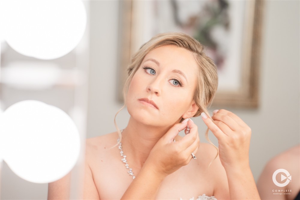 Bride Putting on earrings