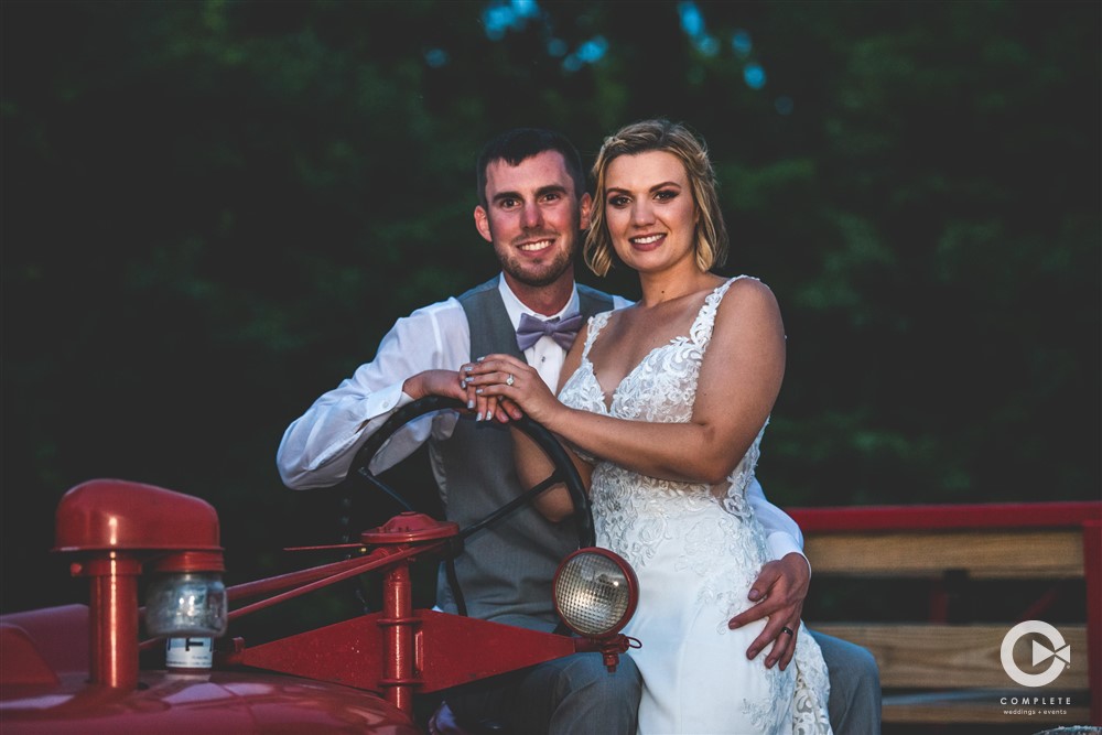 bride and groom on tractor