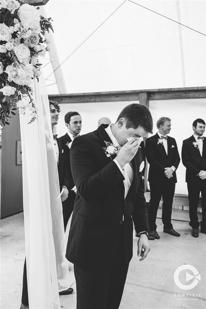 groom crying at alter