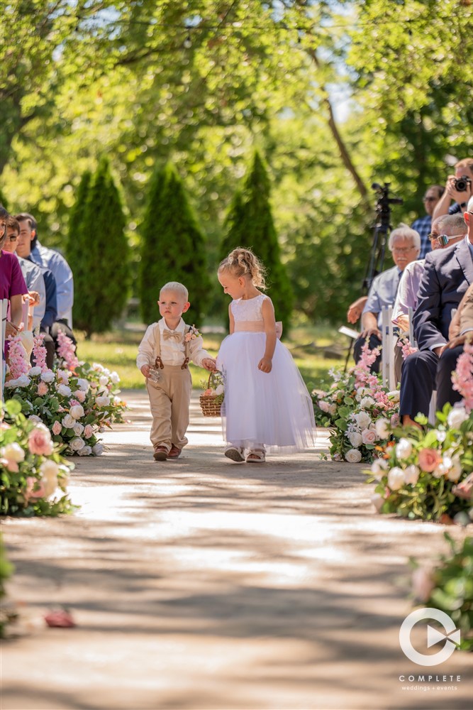 flower girl and ring bear walking down the aisle