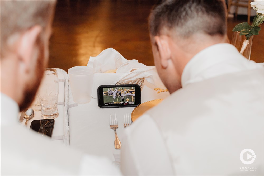 groomsmen watching football