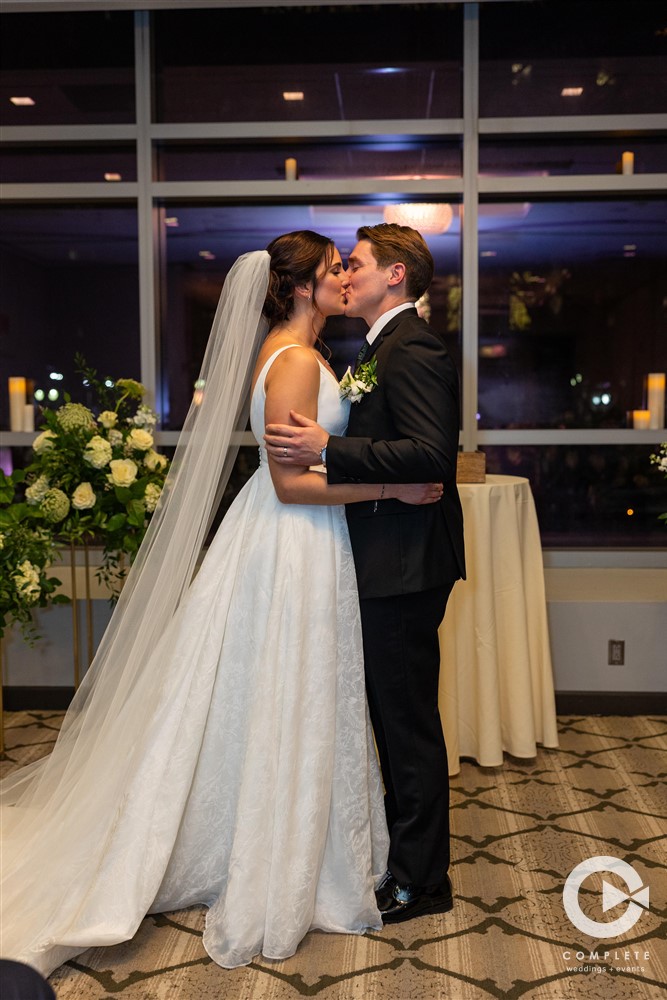 bride and groom kiss