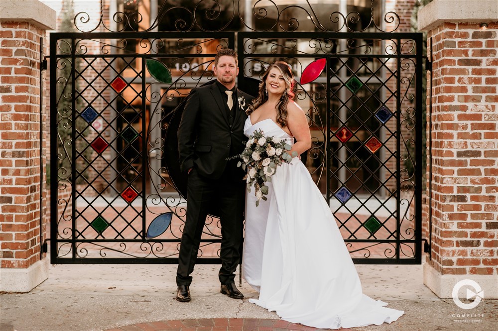 Bride and Groom posing for a photo at Red Mesa Cantina
