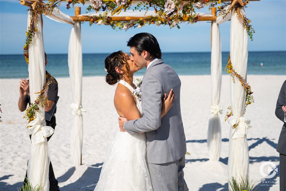 Wedding beach ceremony in Tampa Bay, Florida captured by Complete Weddings + Events Tampa Bay.