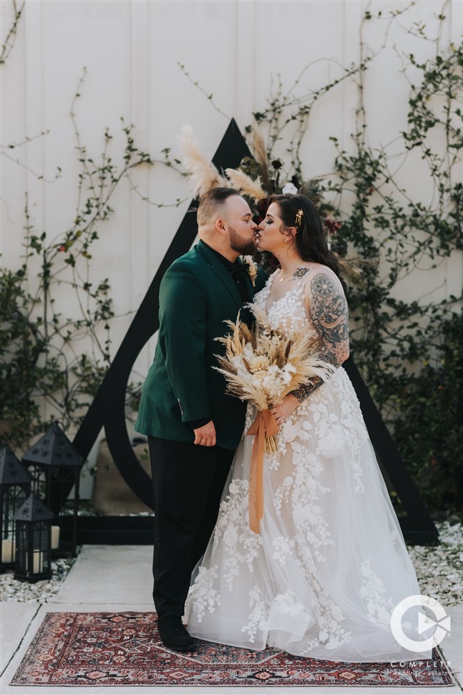 Bride and Groom kiss at Harry Potter themed altar