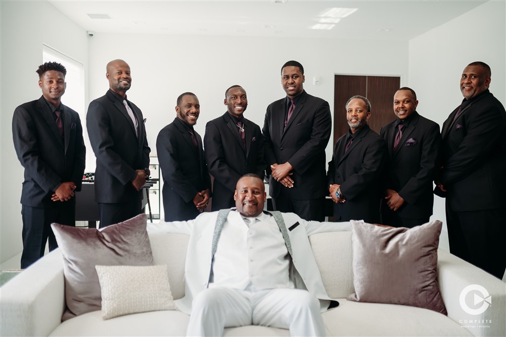 White Suit Groom and Groomsmen Contrast Glass Chapel West