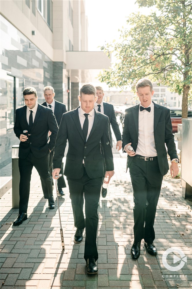 Groomsmen walk around Downtown Tulsa