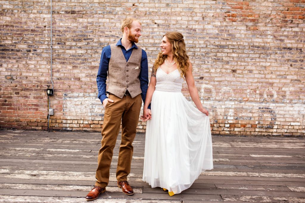 bride and groom pictures brick wall