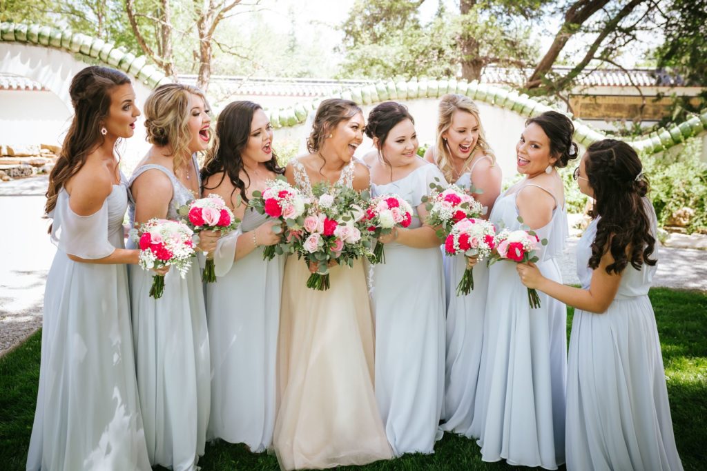 Bride and bridesmaids, standing together at the Botanica Gardens in Wichita, KS.