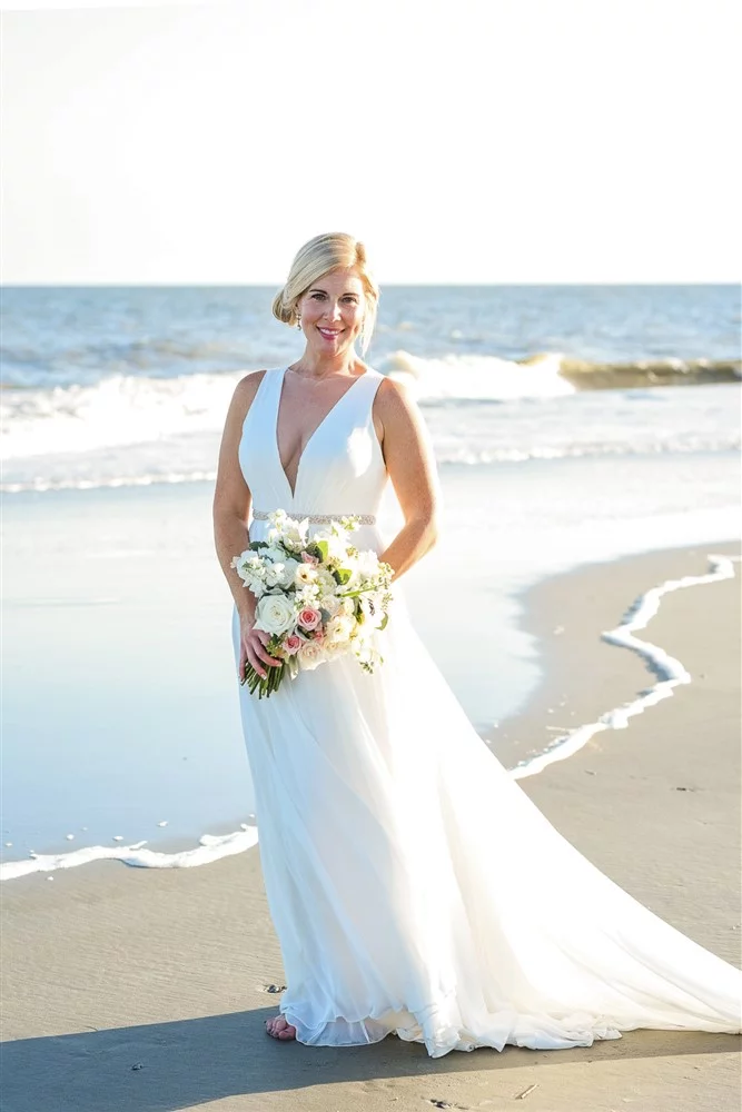Bride on Charleston beach with wedding bouquet