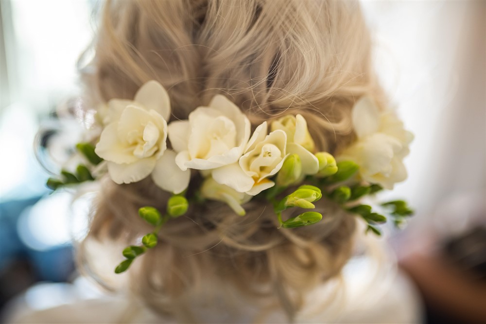 white wedding florals in bride's hair
