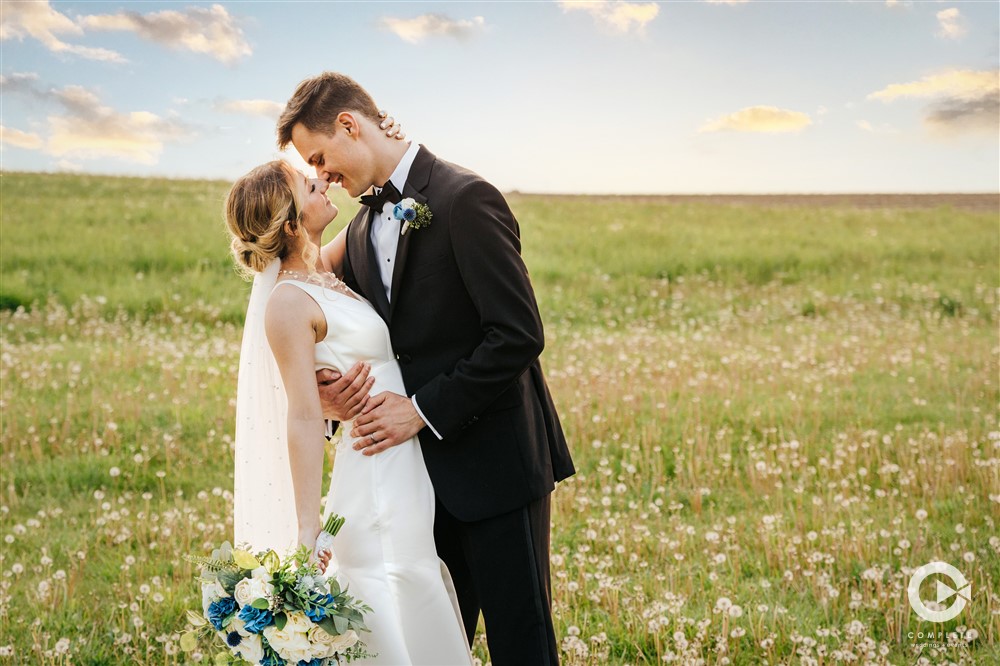 open fields background with bride and groom