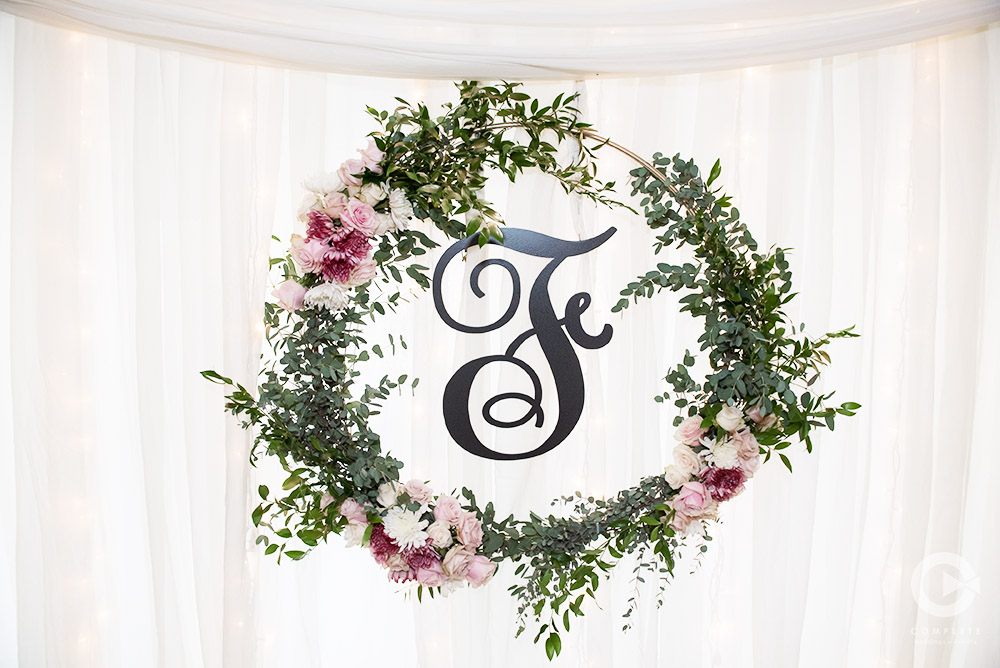 greenery initial sign with pink flowers