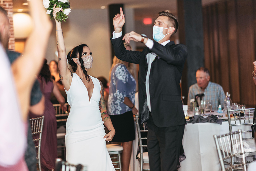 bride and groom in masks