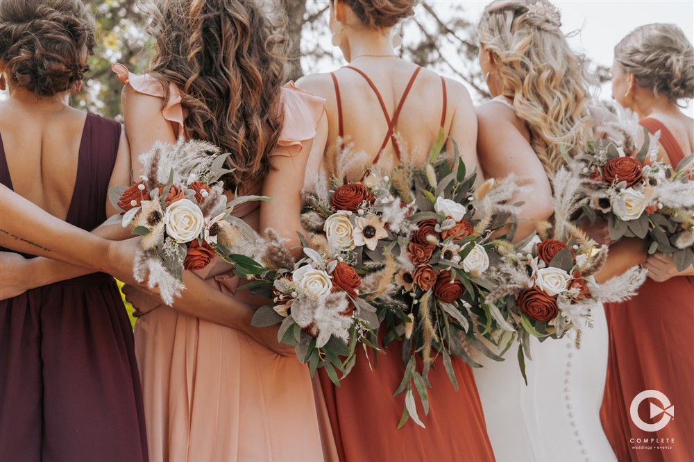 creative wedding photo with bridesmaids and bouquets