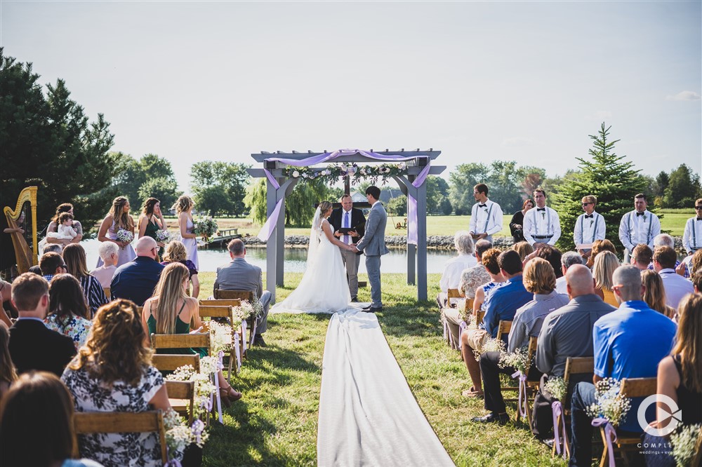 ceremony outdoors with purple decor