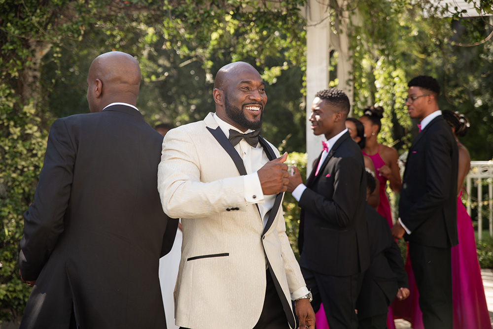 Groom in White Tux and black bow tie