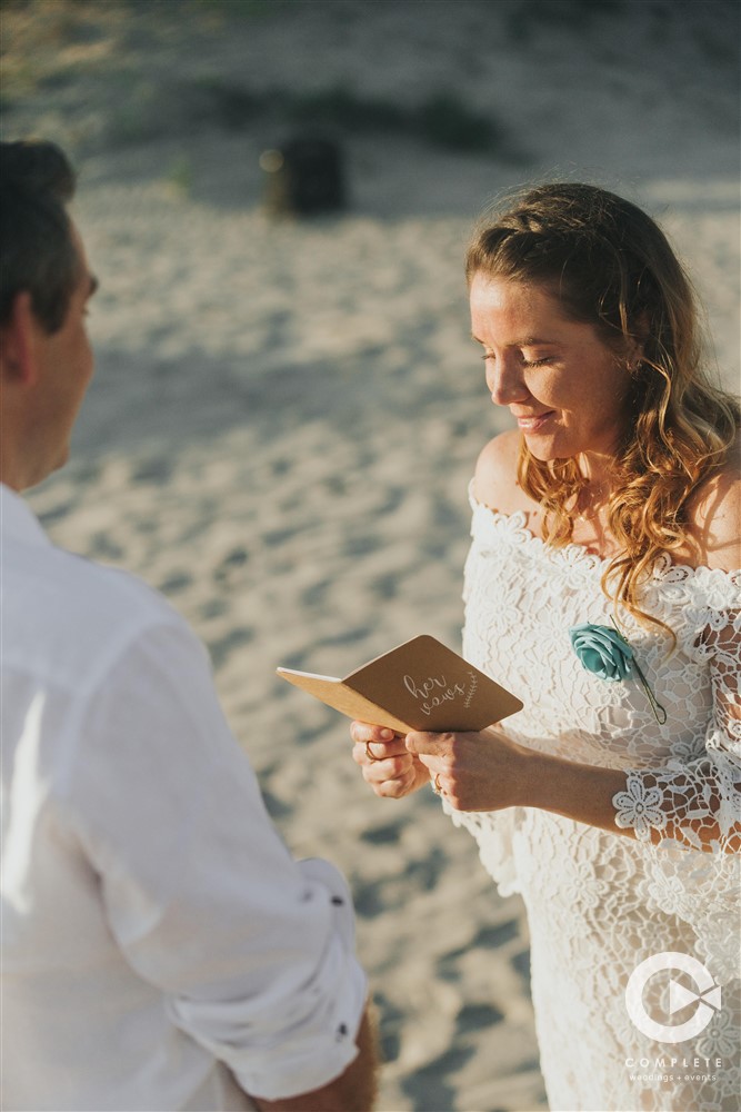 Personalize Your Wedding Ceremony with bride reading at beach wedding
