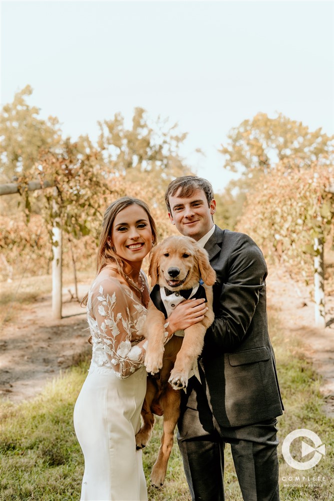 couple at winery with their dog