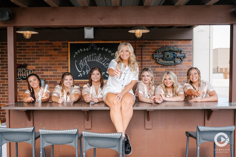 bridesmaids behind the bar